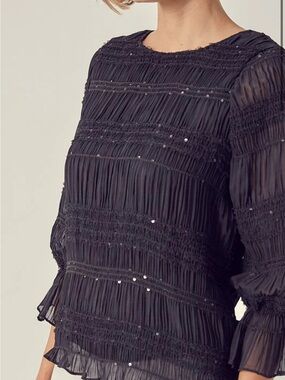 DO+BE smocked top featuring long ruffled sleeves Size S
